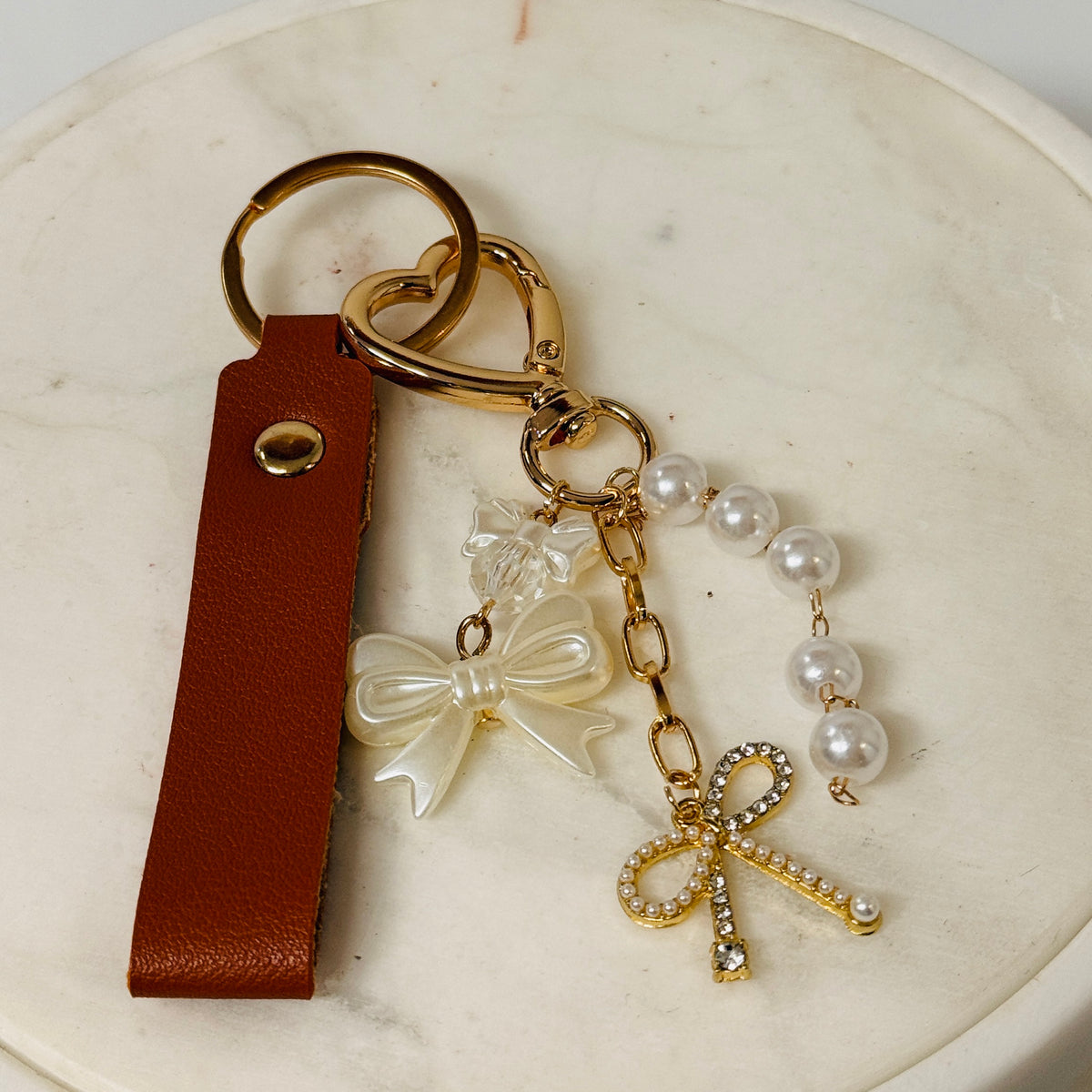 Close-up of bow charm with faux pearls and rhinestones